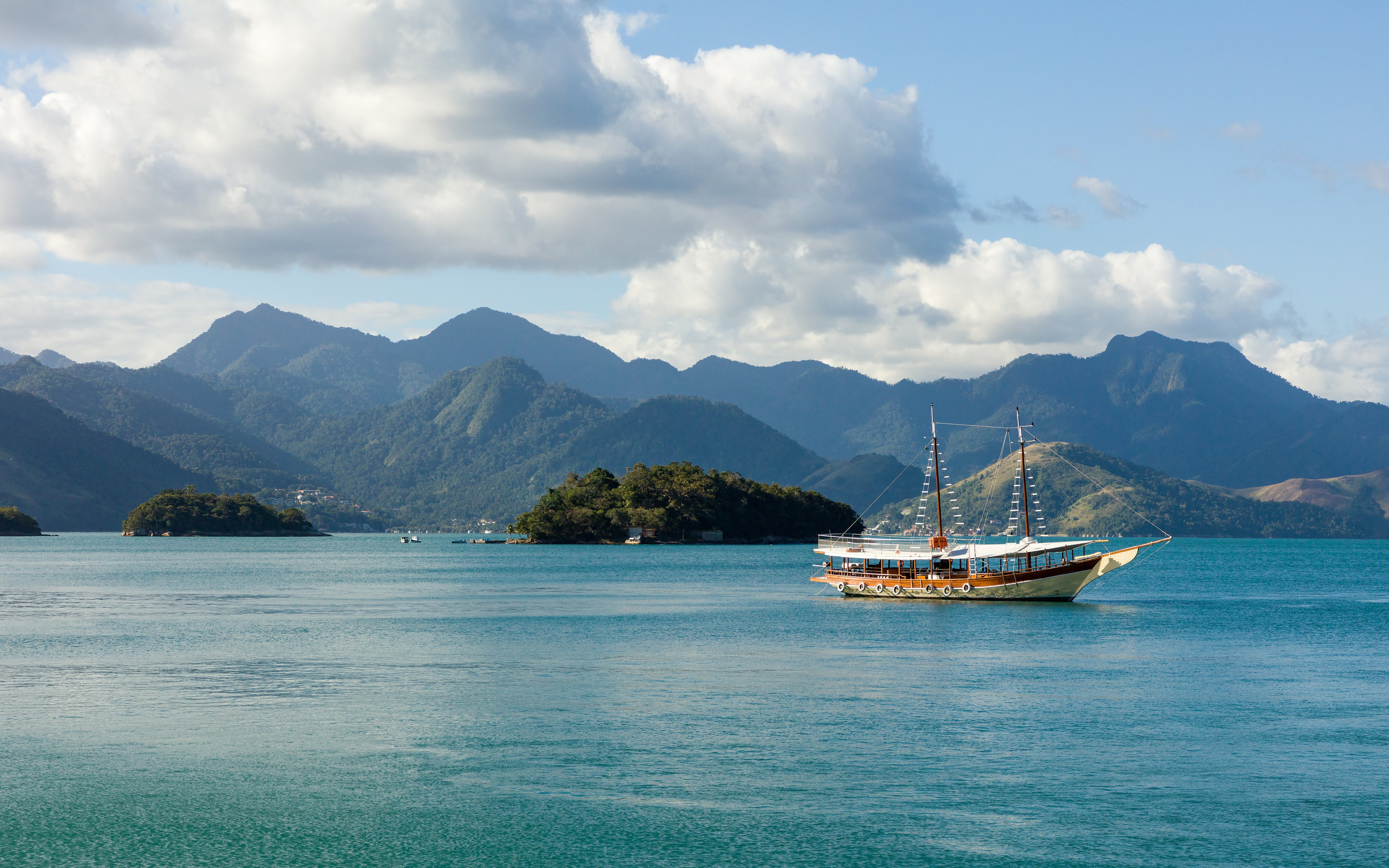 Schooner sailing in Angra dos Reis bay with Ilha Grande mountains, Rio de Janeiro, Brazil.