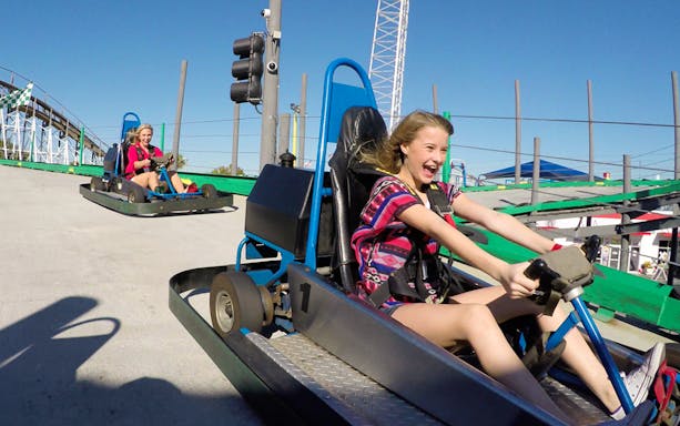 Young girl driving a go-kart at Fun Spot America.