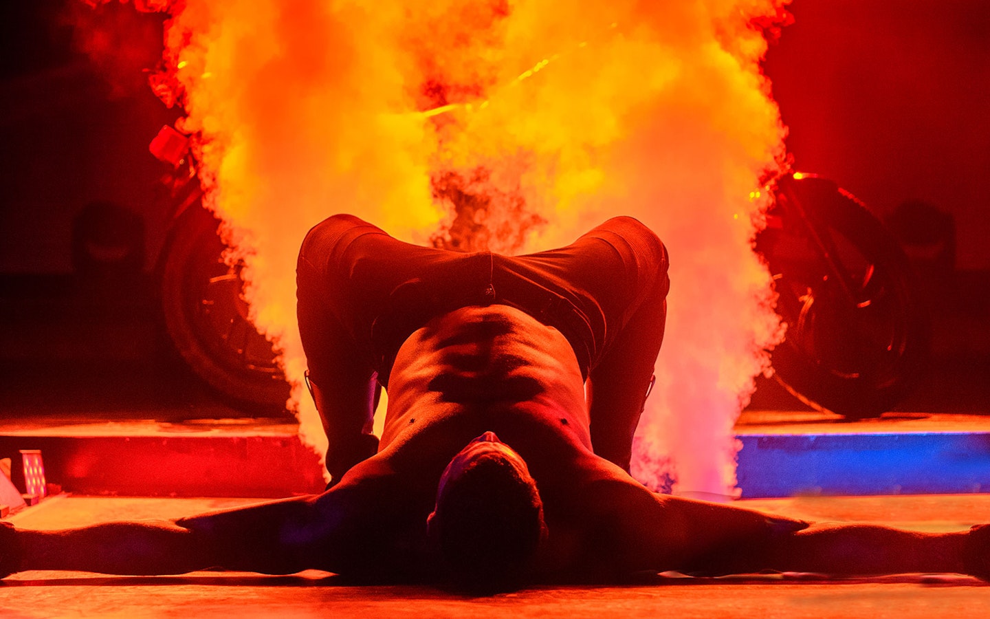 Performer on stage with smoke effects during Chippendales act.