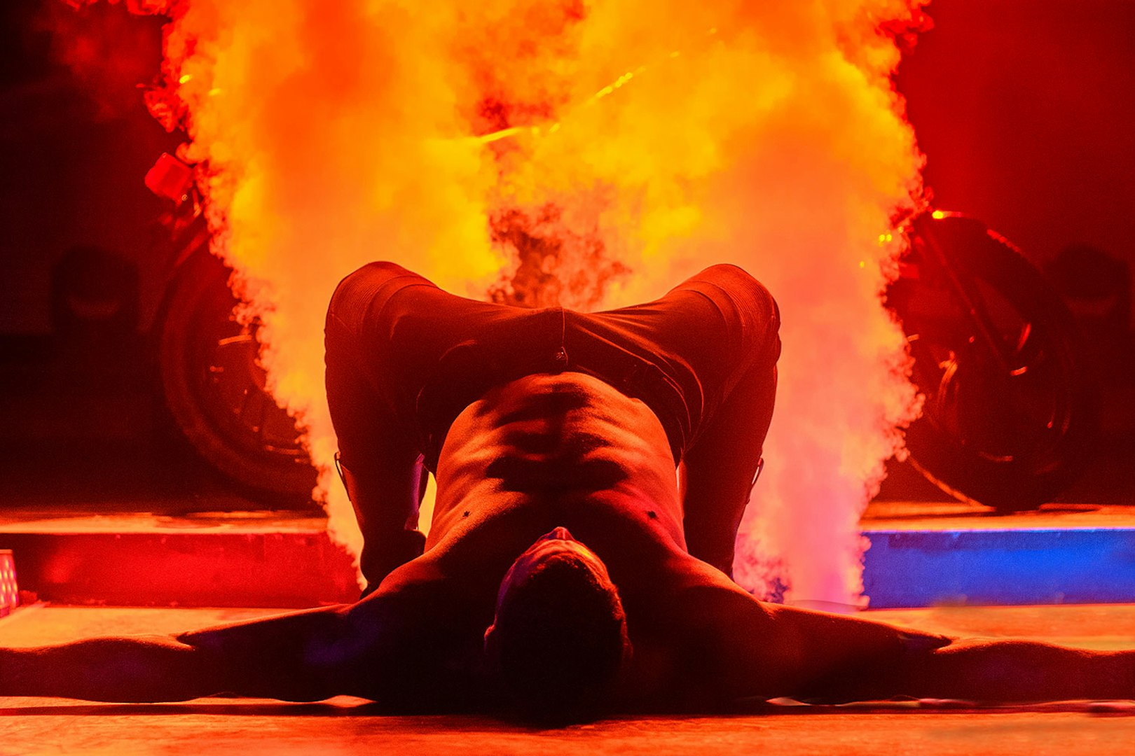 Performer on stage with smoke effects during Chippendales act.