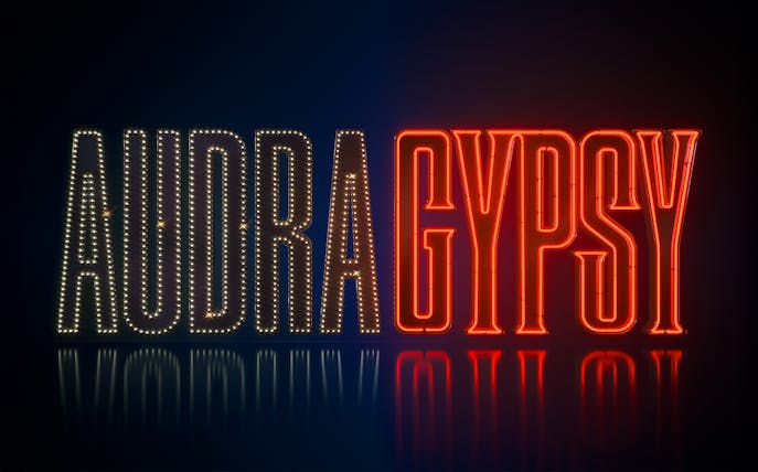 Neon sign displaying 'Audra Gypsy' in illuminated letters