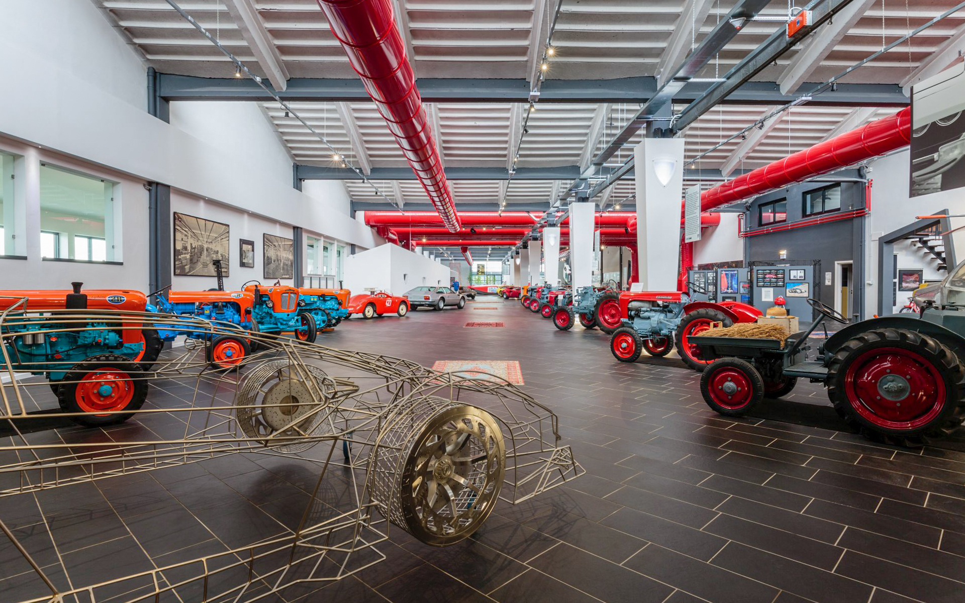 Tractors and car frame display at Ferruccio Lamborghini Museum, Bologna, Italy.