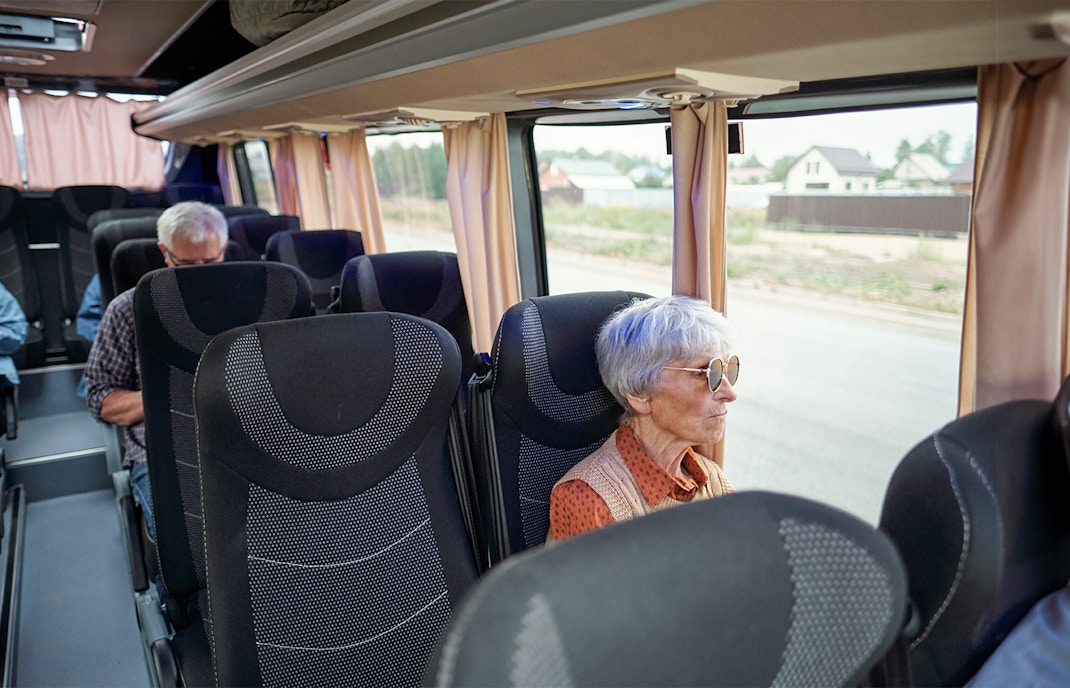 Bus interior with passengers traveling from Madrid to Puy du Fou España.