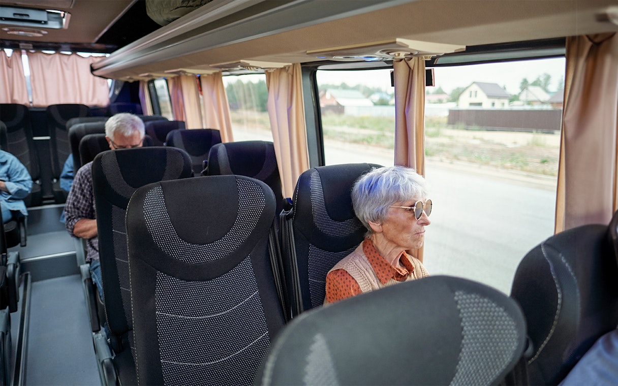 Bus interior with passengers traveling from Madrid to Puy du Fou España.