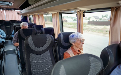 Bus interior with passengers traveling from Madrid to Puy du Fou España.