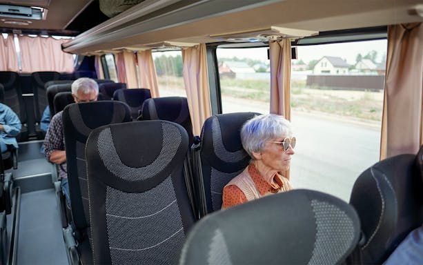 Bus interior with passengers traveling from Madrid to Puy du Fou España.