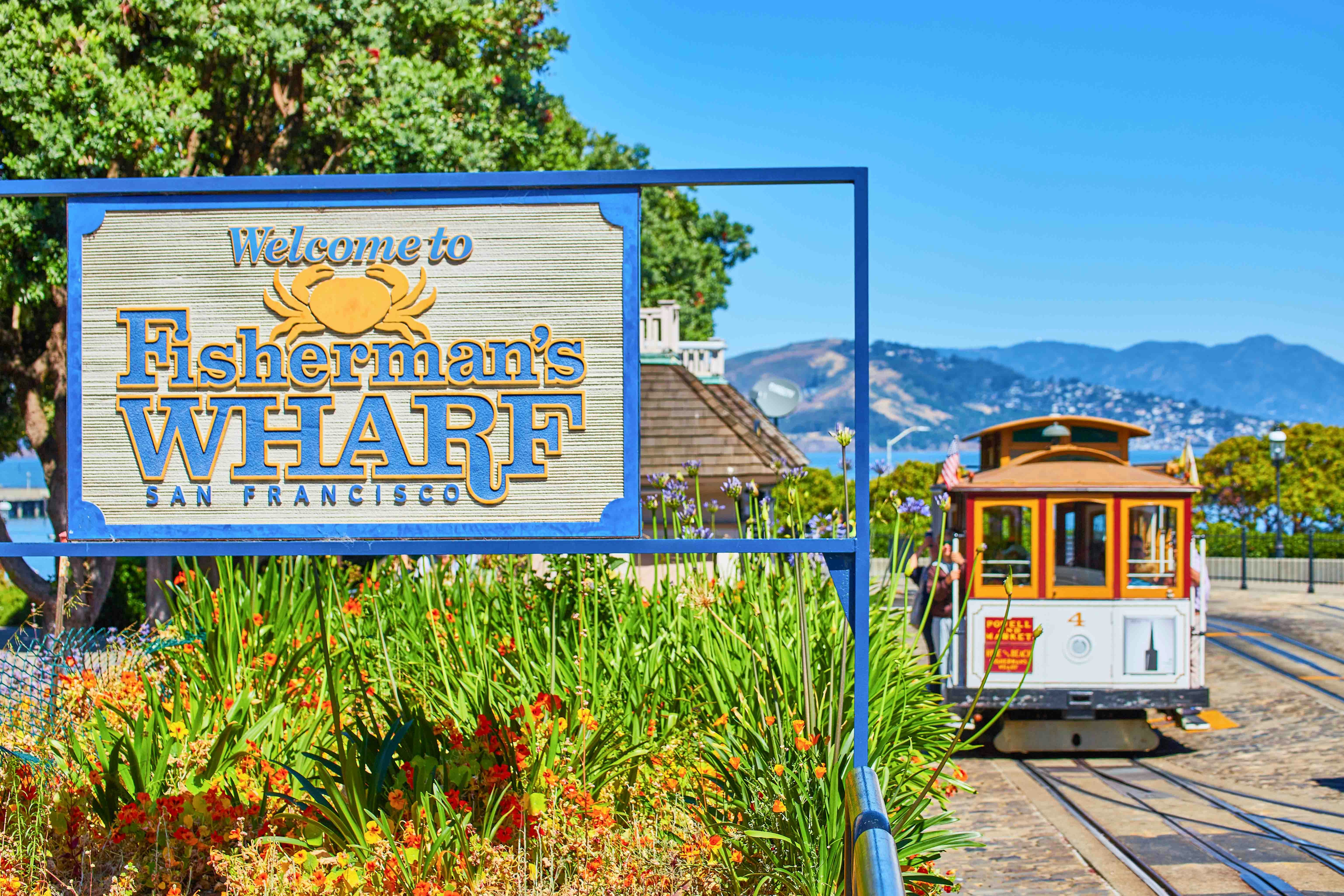 Fisherman’s Wharf sign with a cable car in San Francisco.