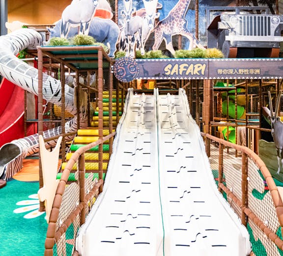 Indoor play area with safari-themed slides and animal decorations at Safari Escape Playland.
