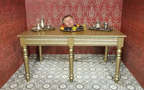 Head illusion on table at Museum of Fantastic Illusions.