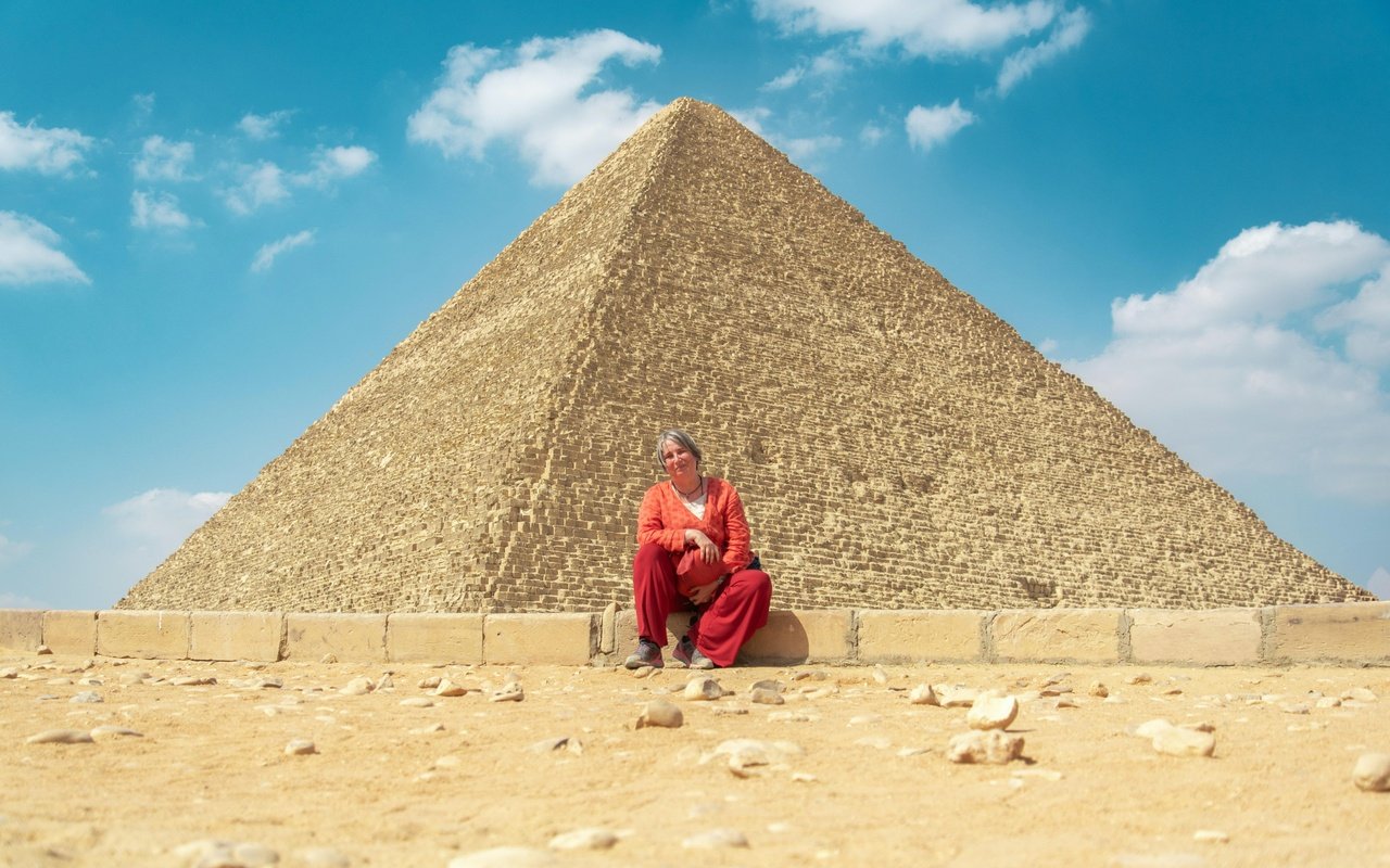 Woman sitting near the Pyramid of Khafre, Cairo day trip from Hurghada.