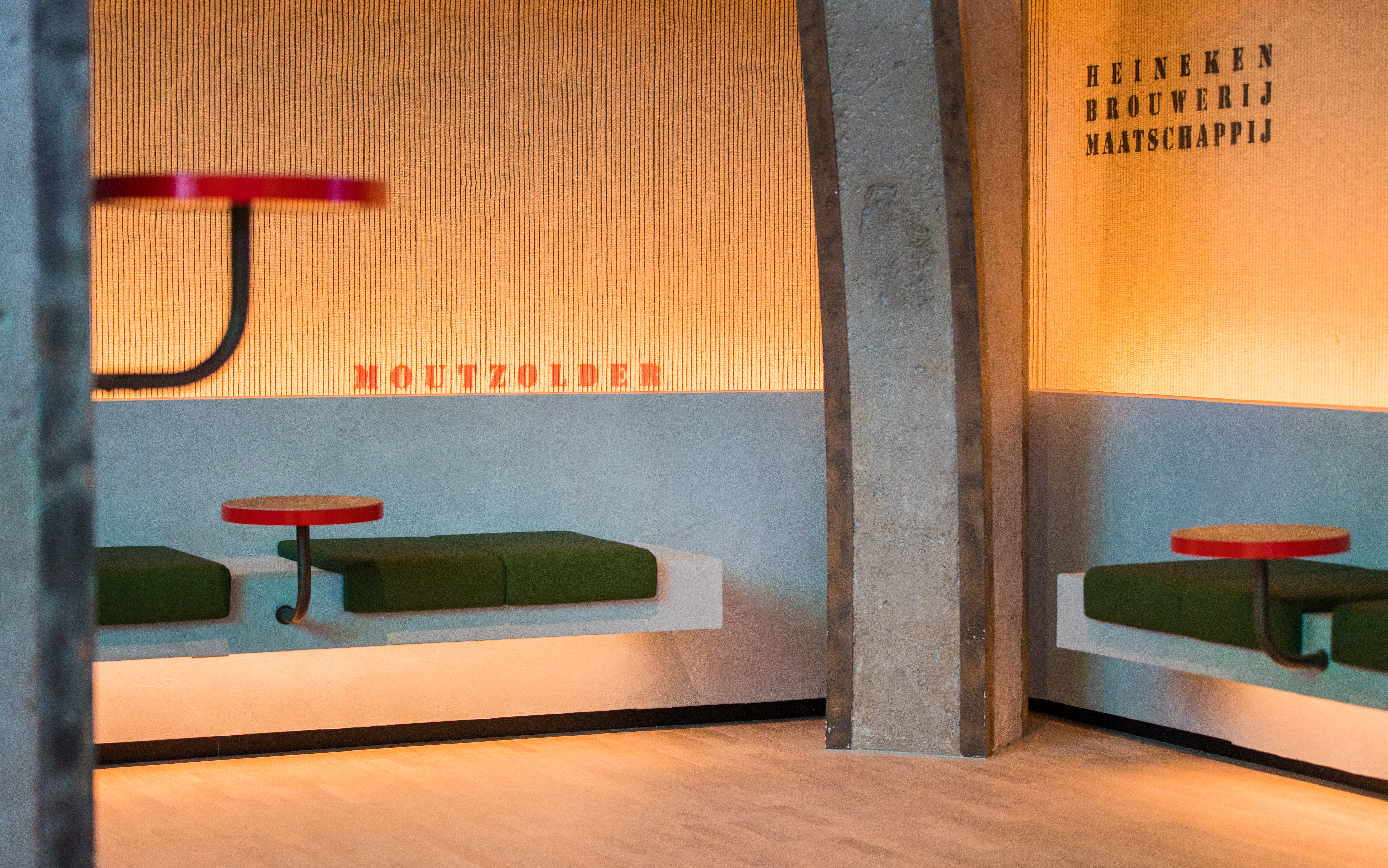 Heineken Rooftop Experience seating area with green benches and red tables.