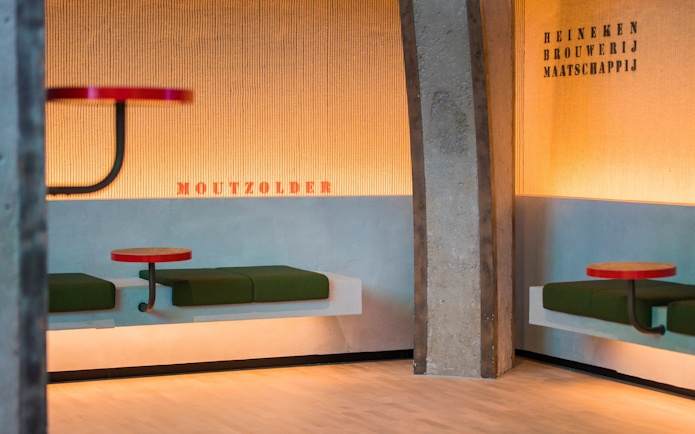 Heineken Rooftop Experience seating area with green benches and red tables.