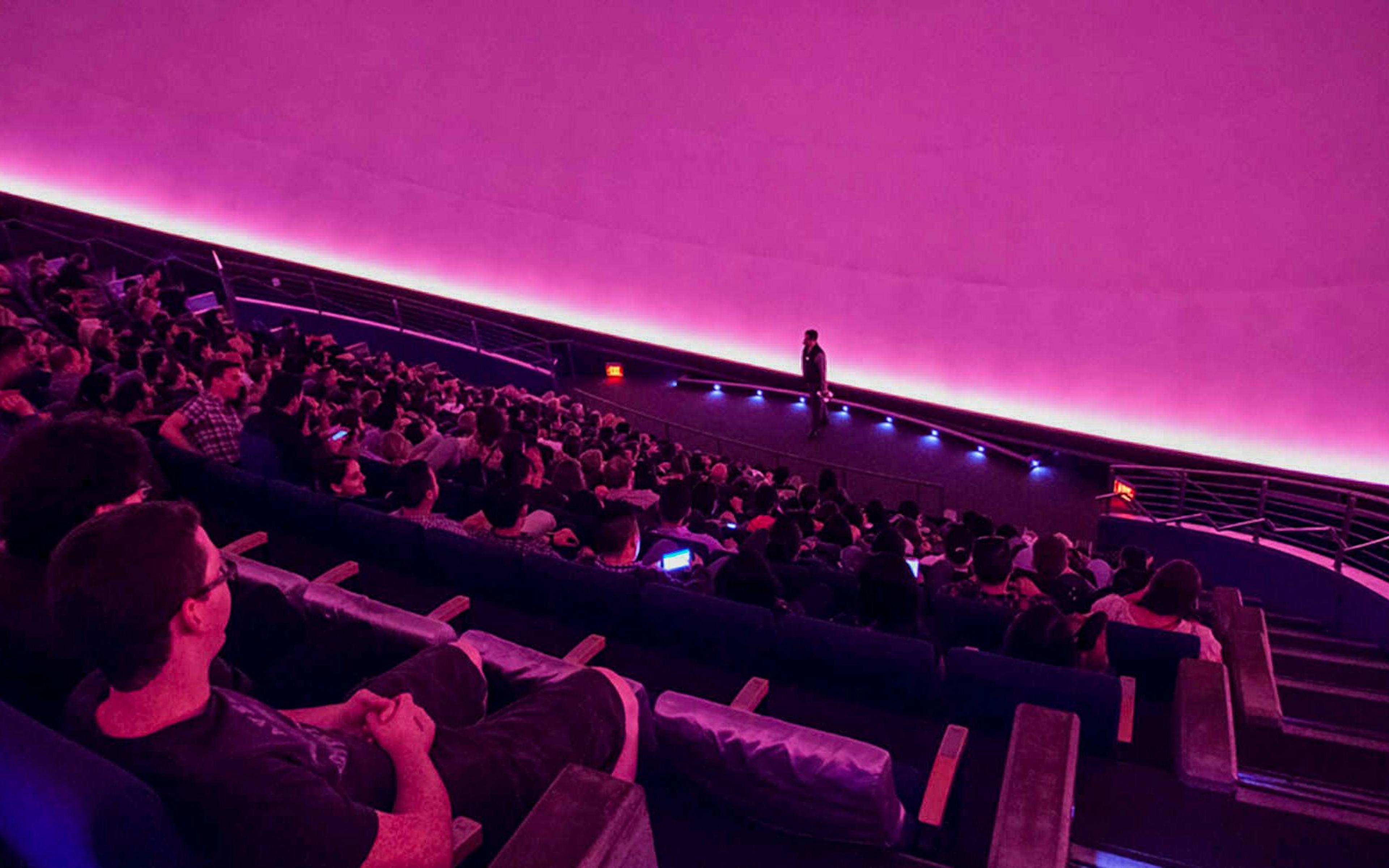 Audience watching a presentation in the planetarium at California Academy of Sciences.
