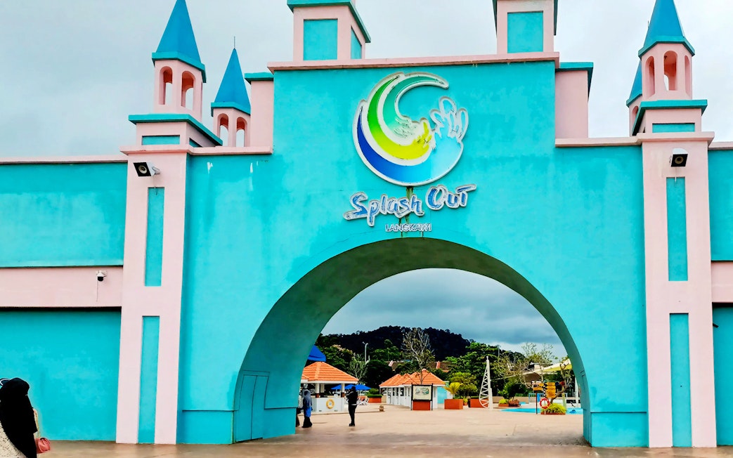 Entrance of Splash Out Langkawi Water Theme Park with colorful archway and towers.
