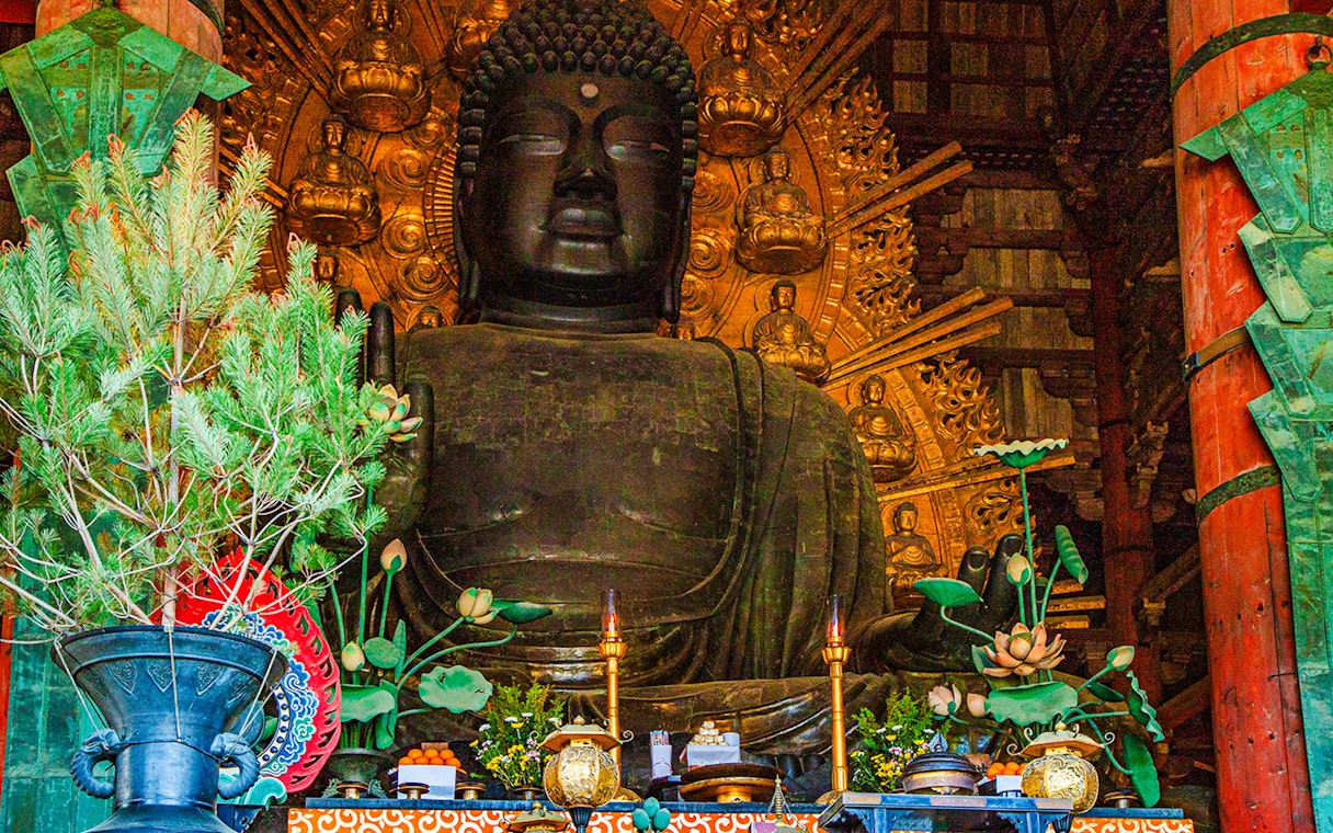 Buddha statue with offerings inside Tōdai-ji Temple, Nara, Japan.