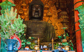 Buddha statue with offerings inside Tōdai-ji Temple, Nara, Japan.