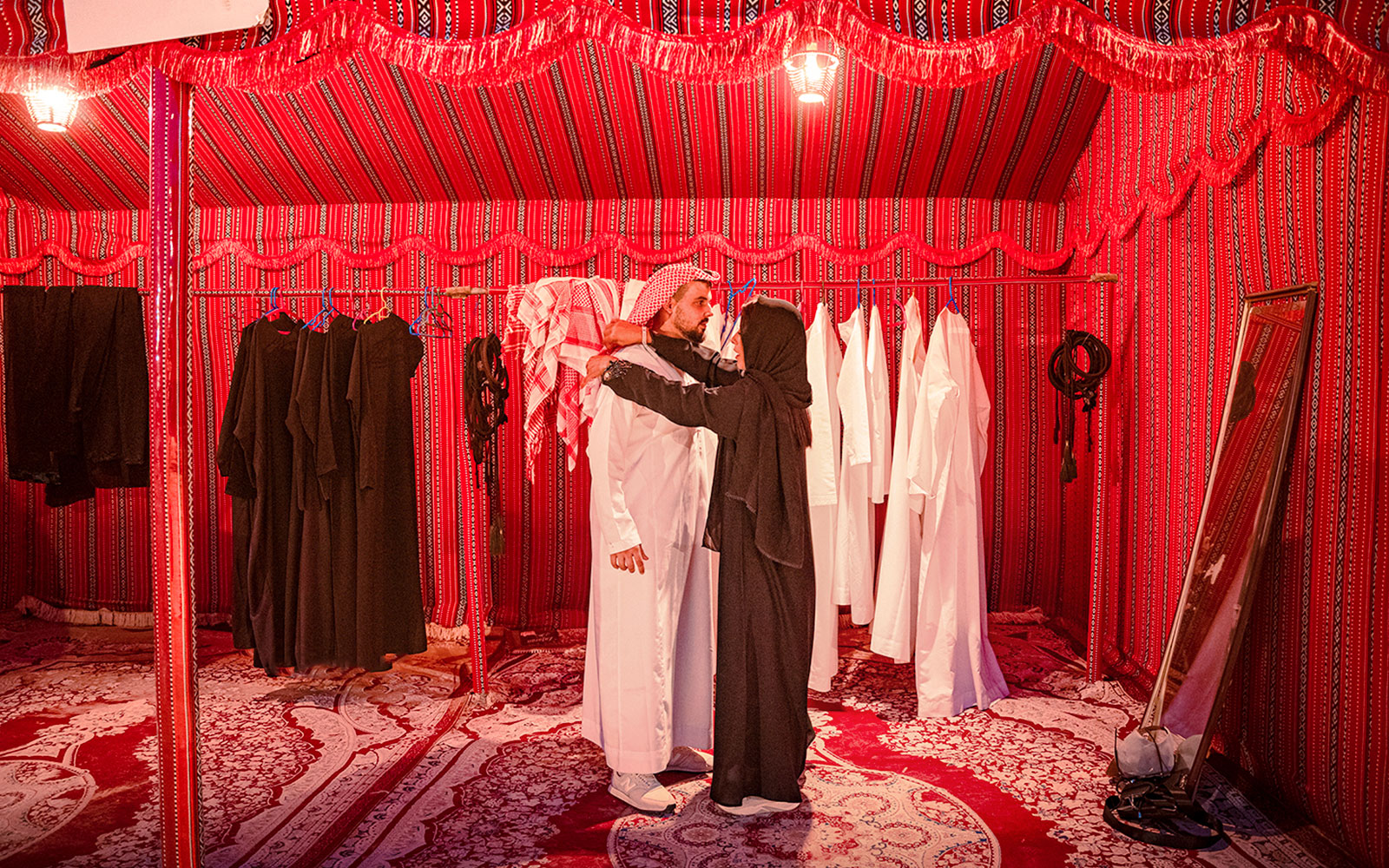 Traditional clothing fitting in Abu Dhabi desert safari tent.