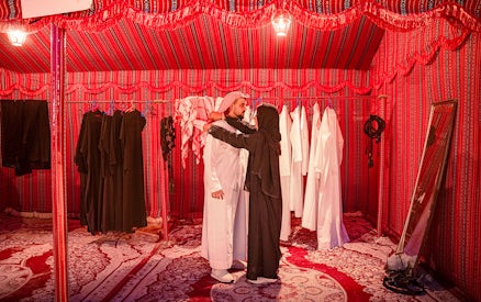 Traditional clothing fitting in Abu Dhabi desert safari tent.