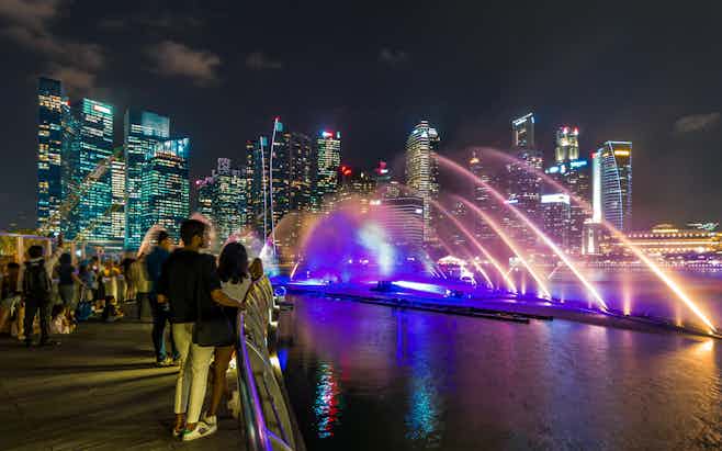 Marina Bay Sands light show at Singapore's waterfront promenade.