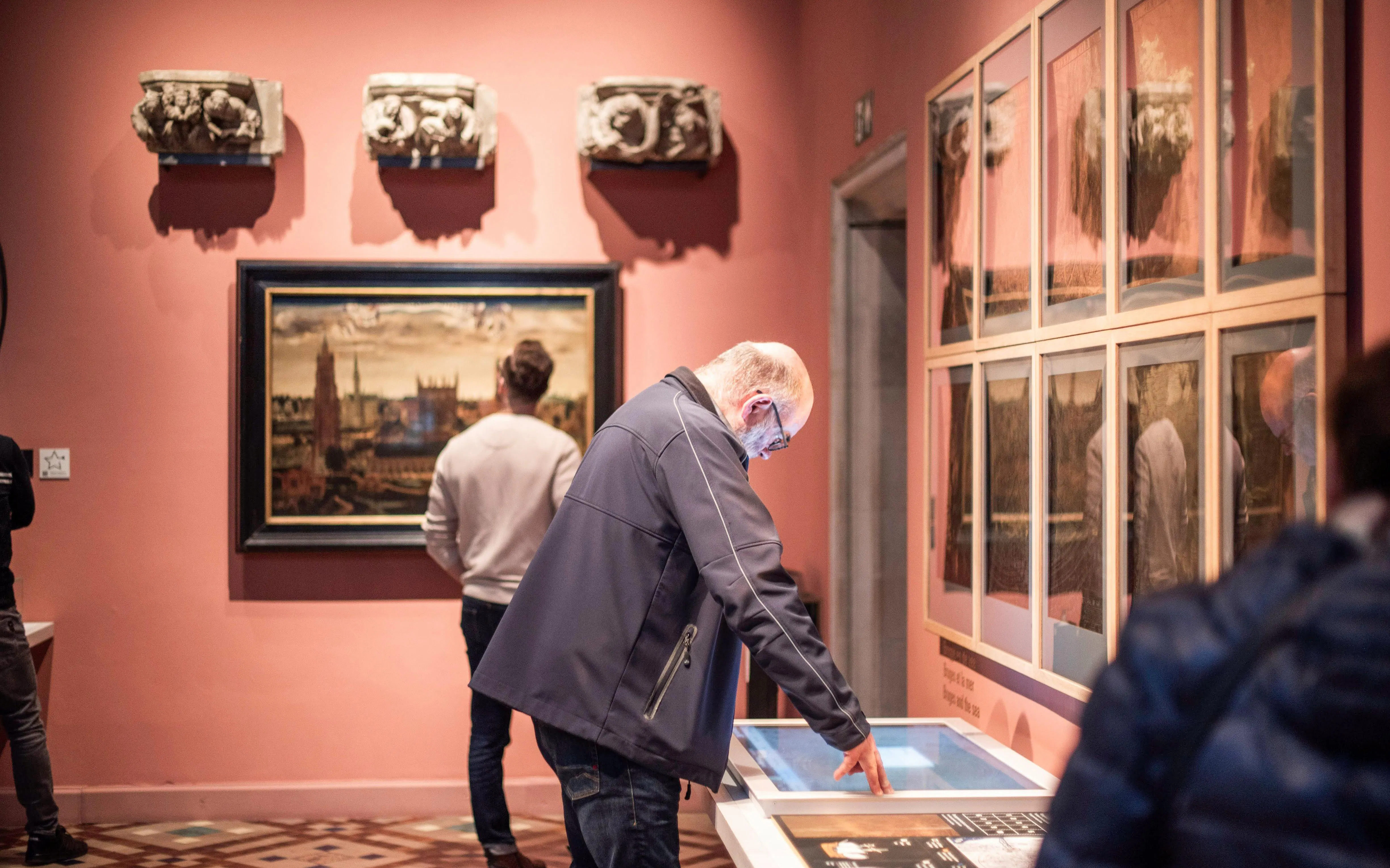 Visitors exploring exhibits at Gruuthusemuseum in Bruges.