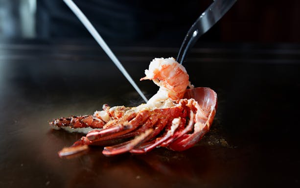 Grilled lobster being prepared at Teppanyaki Ichou, part of the Kuroge Wagyu beef course.