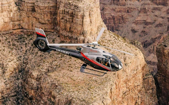 Helicopter flying over Grand Canyon West during Las Vegas tour with canyon landing.