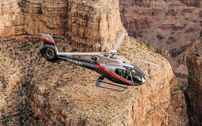 Helicopter flying over Grand Canyon West during Las Vegas tour with canyon landing.