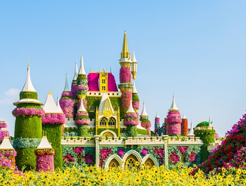 Floral castle display at Dubai Miracle Garden with vibrant flowers and towers.