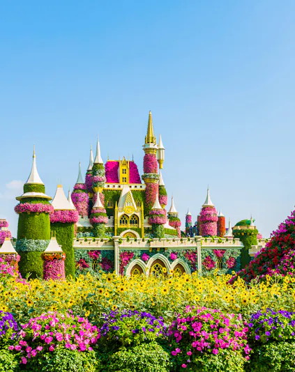 Floral castle display at Dubai Miracle Garden with vibrant flowers and towers.