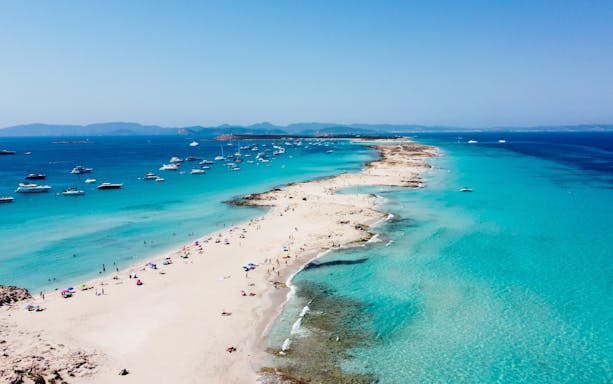 Ses Illetes beach with turquoise waters and boats, Formentera, Balearic Islands, Spain.