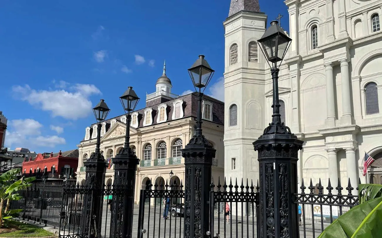 St. Louis Cathedral and Cabildo in New Orleans under a clear sky.
