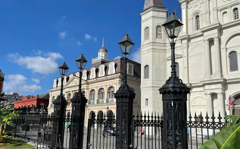 St. Louis Cathedral and Cabildo in New Orleans under a clear sky.