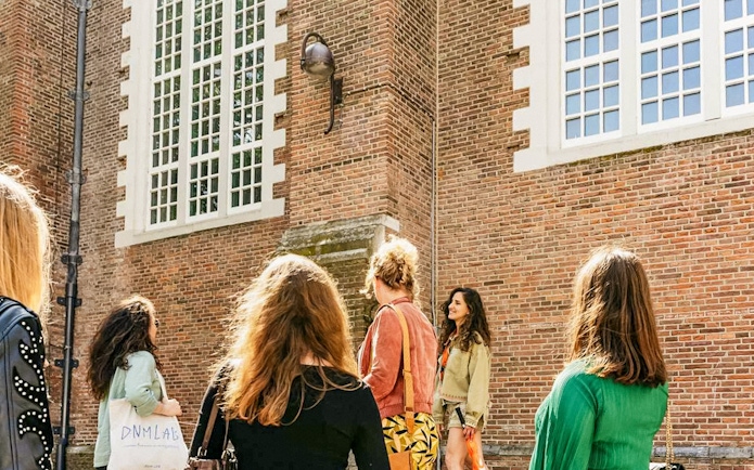 Tour group outside a historic building on the Anne Frank Walking Tour in Amsterdam.