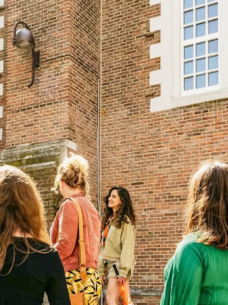 Tour group outside a historic building on the Anne Frank Walking Tour in Amsterdam.