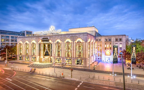 Friedrichstadt-Palast stage with performers in vibrant costumes during BLINDED by DELIGHT show, Berlin.