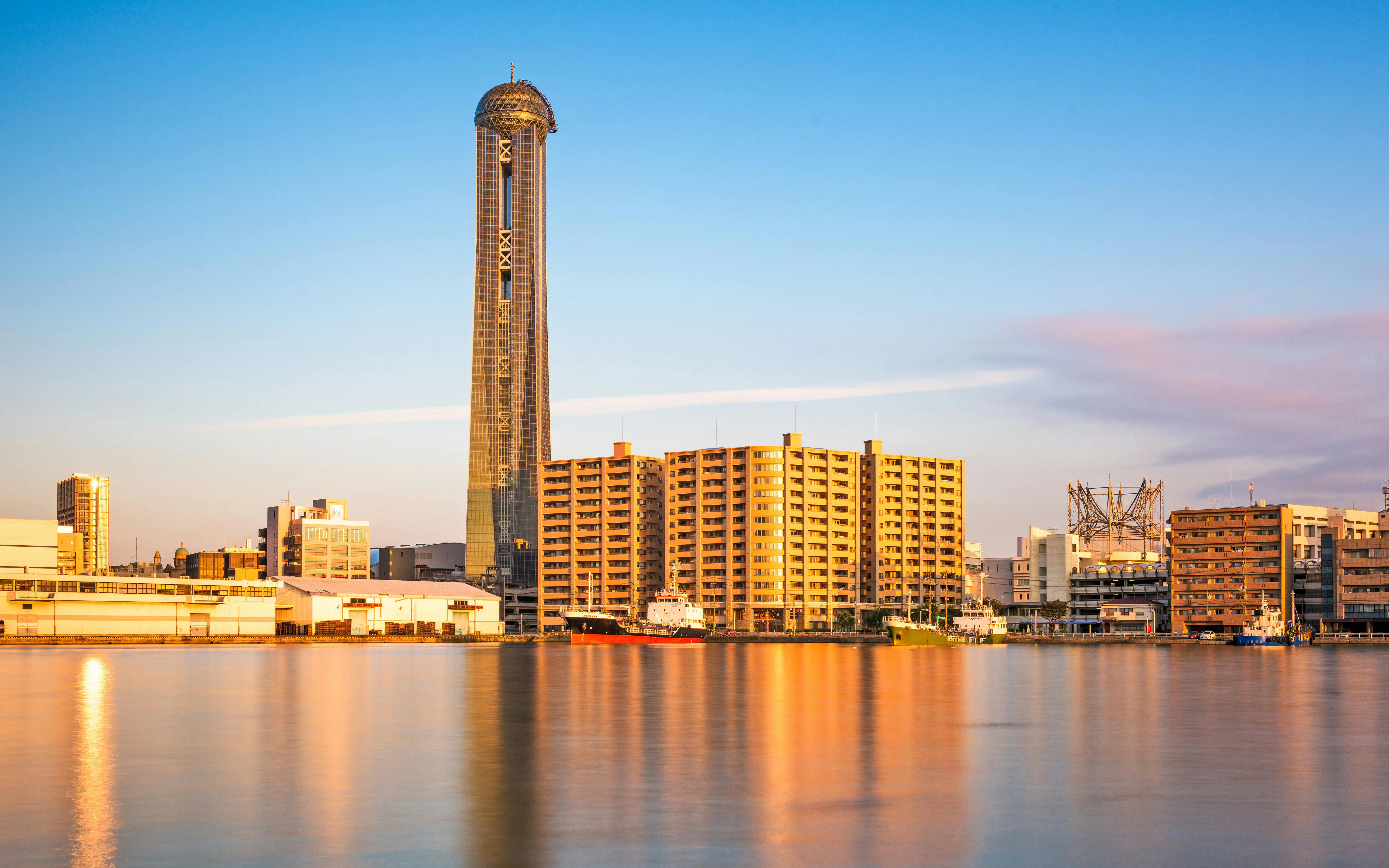 Shimonoseki waterfront skyline with tower and buildings reflecting in the water, Japan.