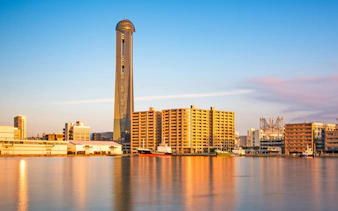 Shimonoseki waterfront skyline with tower and buildings reflecting in the water, Japan.