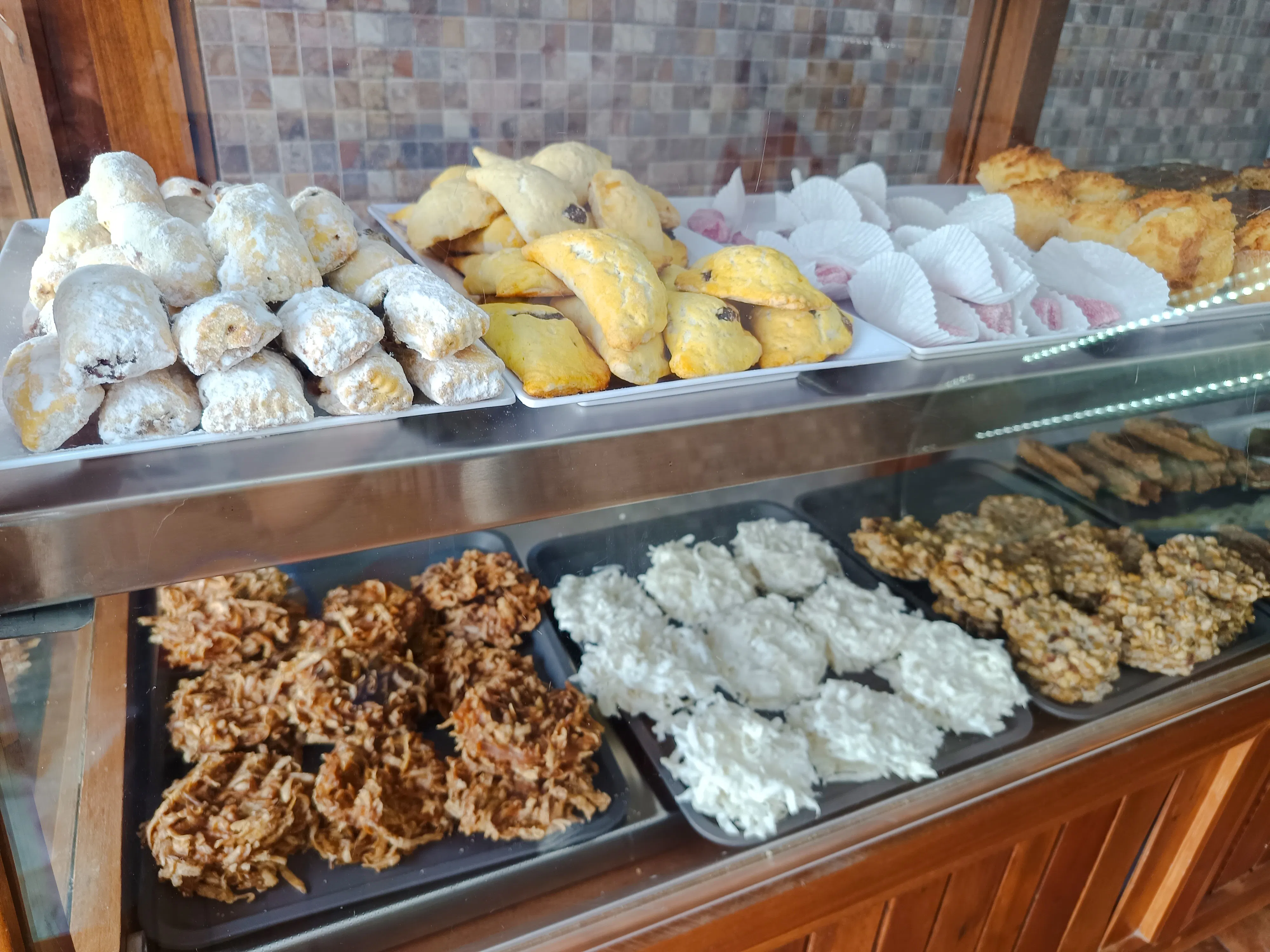 Assorted Dominican pastries and sweets displayed in a bakery during Santo Domingo food tour.