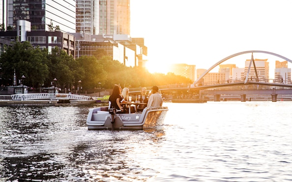 Group enjoying a self-drive picnic cruise on Yarra River at sunset, Melbourne.