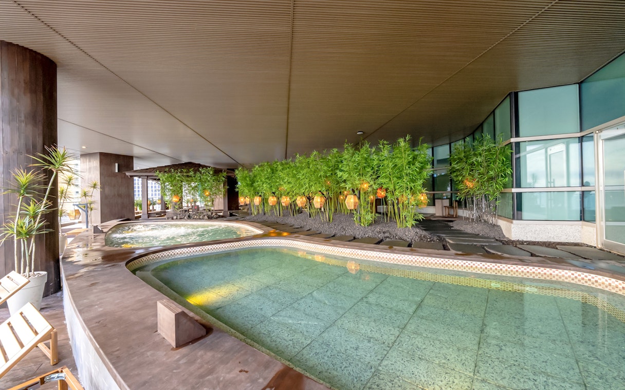 Indoor jjimjilbang spa pools with bamboo decorations at Club D Oasis.