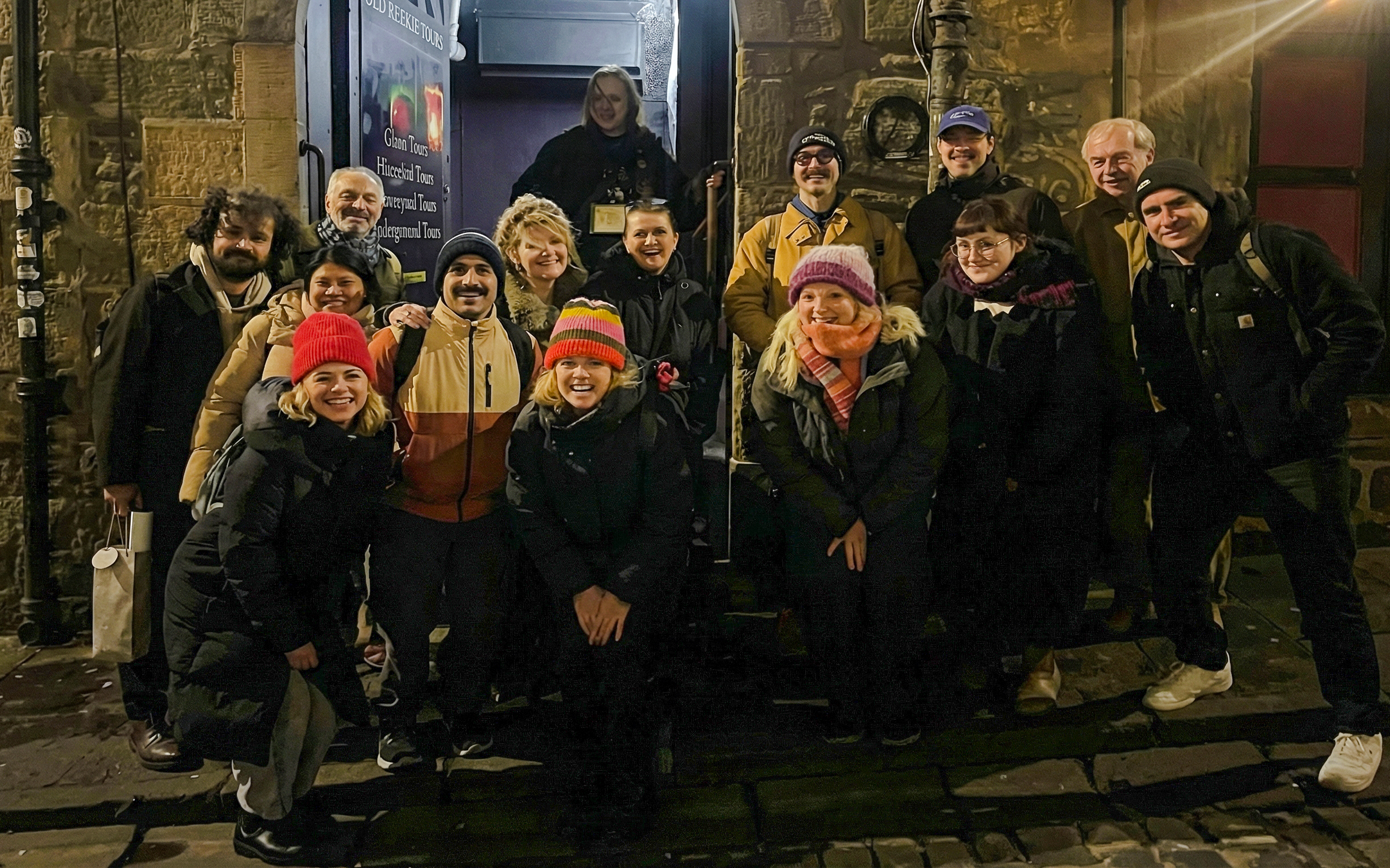 Tourists gathered outside a historic building during a night tour.