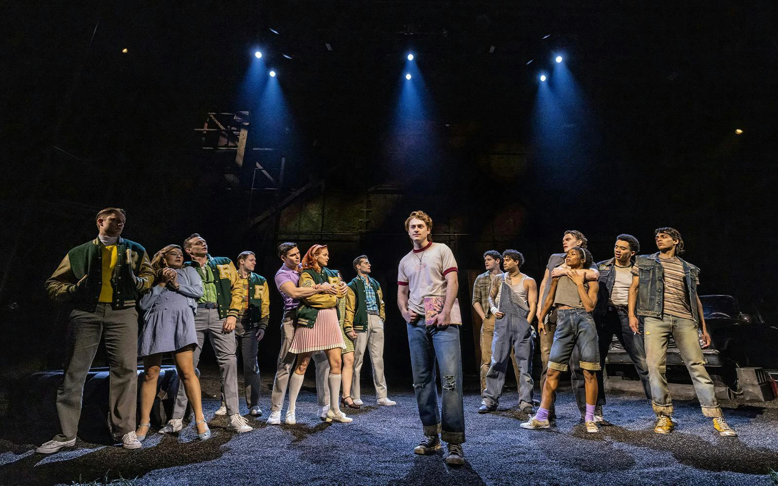 Cast performing a scene from The Outsiders on Broadway stage.