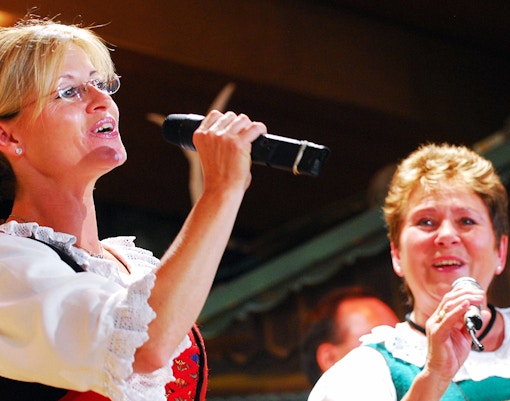 Singers performing at Tyrolean Evening Folk Show in traditional attire.