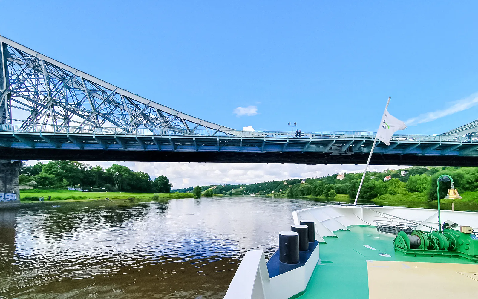 Paddle steamer cruising under Blue Wonder Bridge on the Elbe River in Dresden.