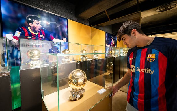 Viewing Ballon d'Or trophies at Camp Nou Museum, Barcelona.