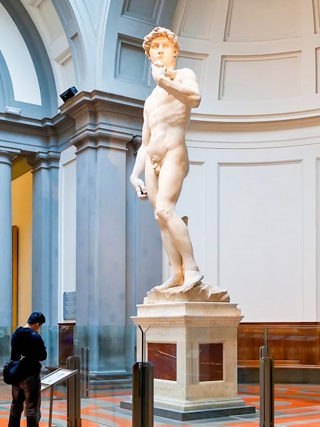 Visitors viewing Michelangelo's David in Hall of the Tribune, Accademia Gallery, Florence.