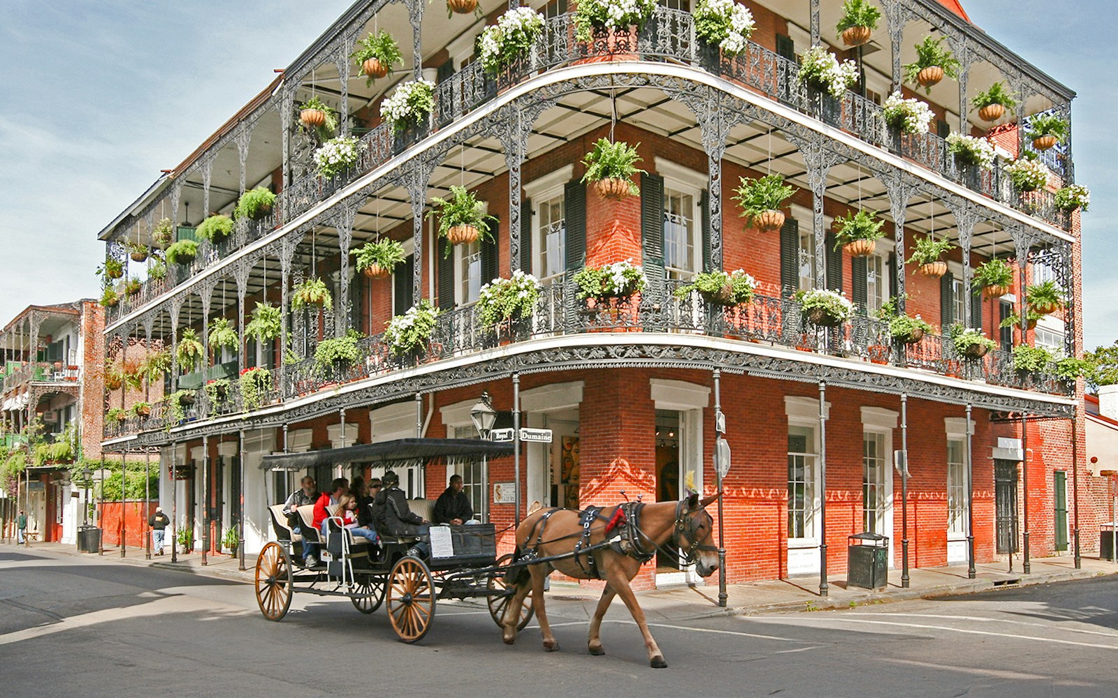 A horse carriage carrying people at the French Quarters in New Orleans.