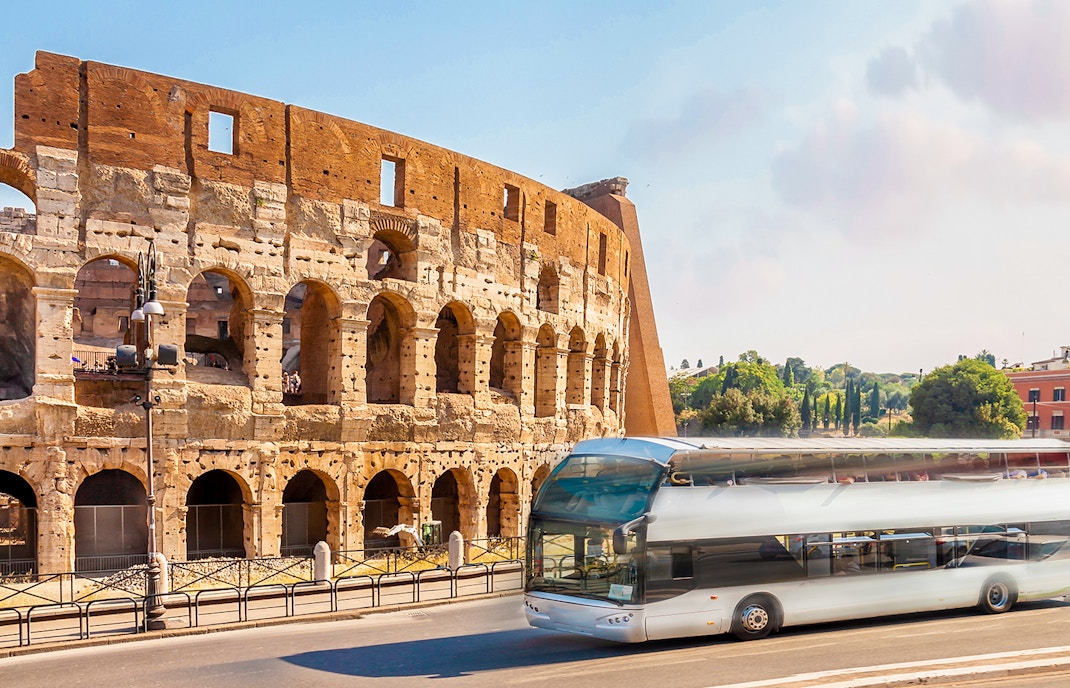 Rome city bus navigating historic streets, showcasing local transportation.