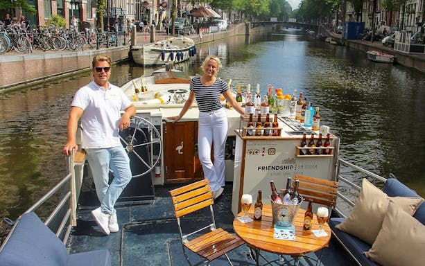Luxury canal cruise in Amsterdam with drinks and scenic views.