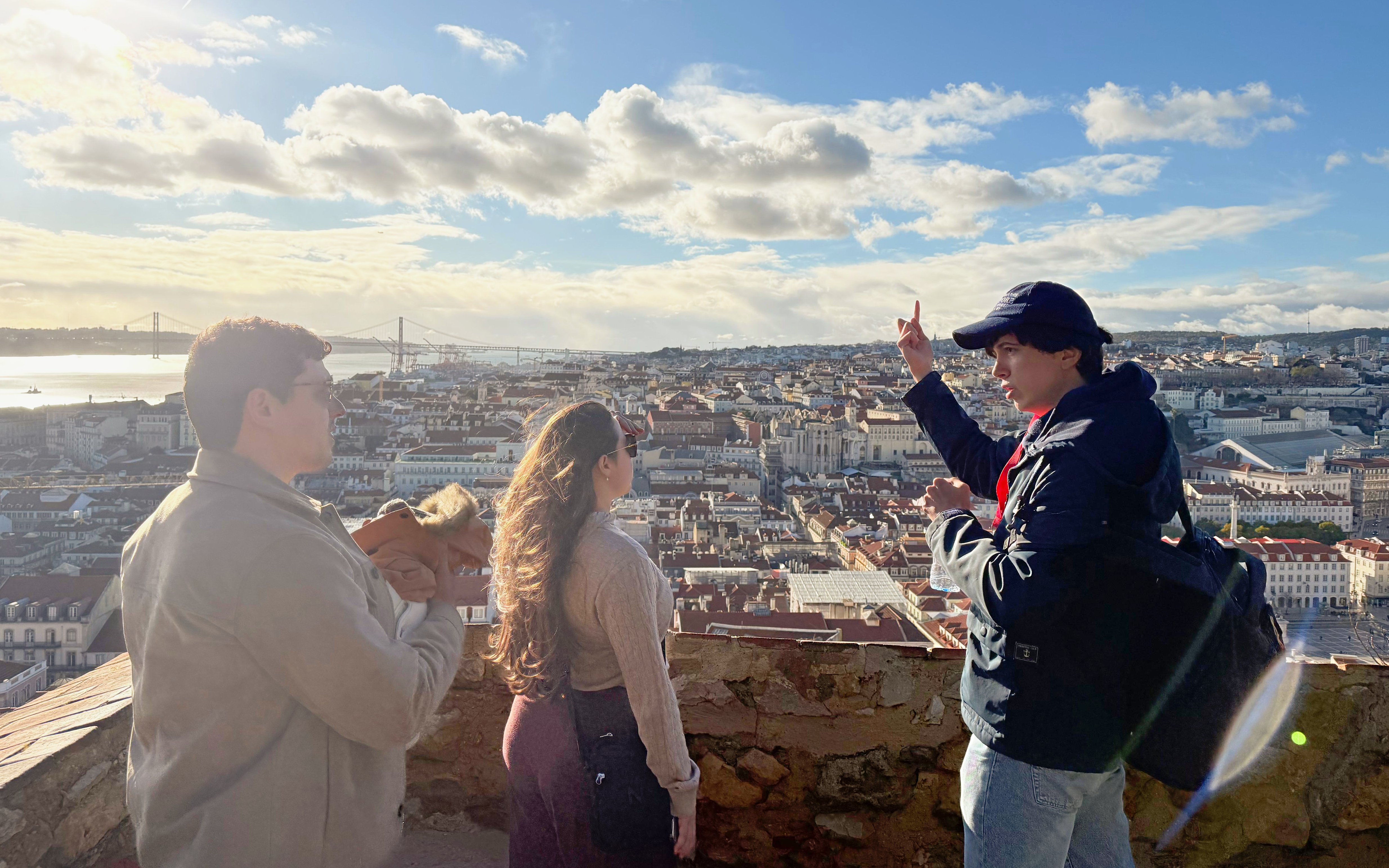 Tourist with guide overlooking Lisbon from São Jorge Castle viewing area.